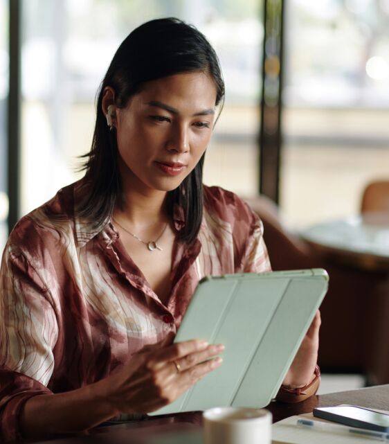 woman reading news on tablet