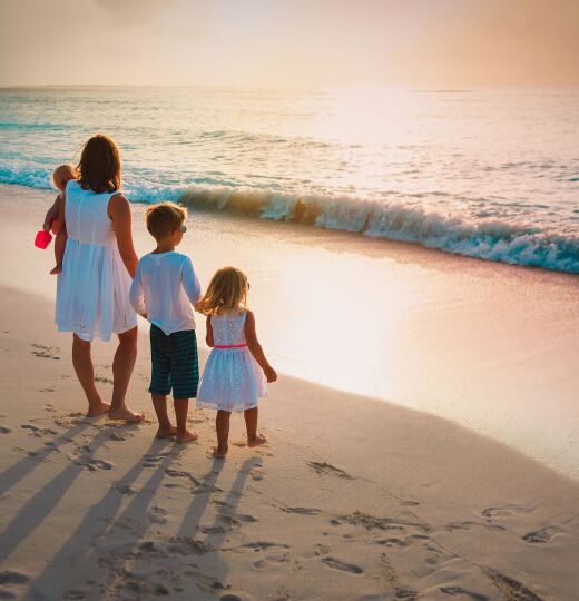 bigstock Mother With Kids Walk On Sand  356027282