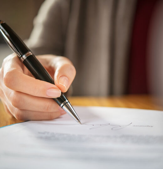 bigstock Close up of woman hand signing 419263108