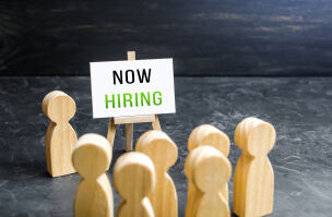 bigstock A Man With A Now Hiring Sign A 441288767