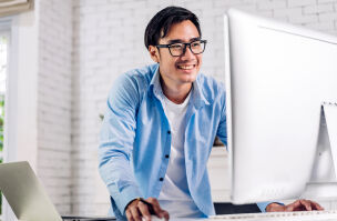 bigstock Young Smiling Asian Man Using  465612805
