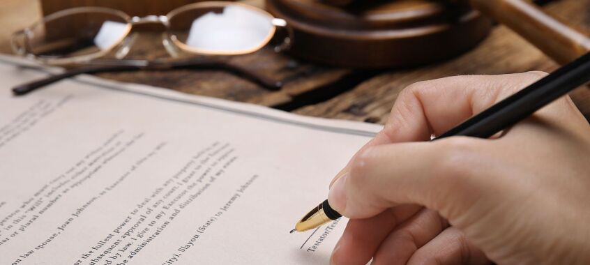 bigstock Woman Signing Last Will And Te 462384991