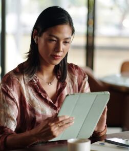 woman reading news on tablet