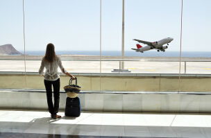 bigstock Girl at the airport window loo 26611379