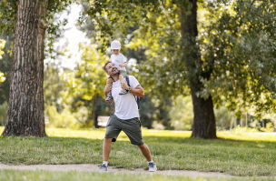 bigstock Dad Carries His Son On His Bac 469009627