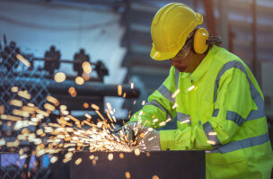 bigstock A Worker Is Using A Steel Grin 462535443