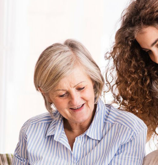 3 generations of women looking at photo album