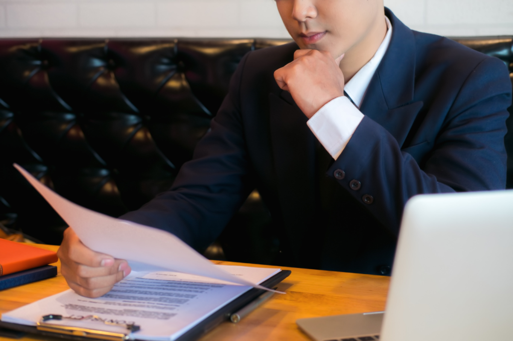 Male Manager Reviewing Resume Information