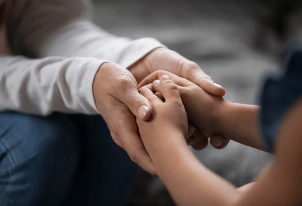 Adult holding a child's hand