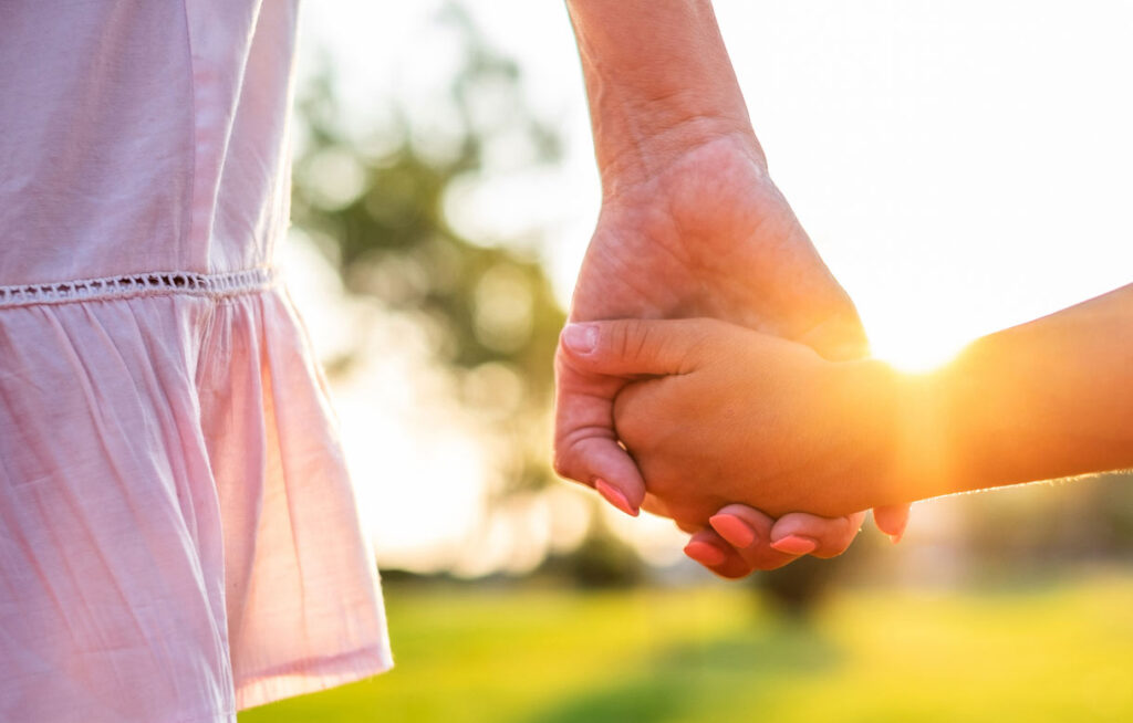Holding hands with child