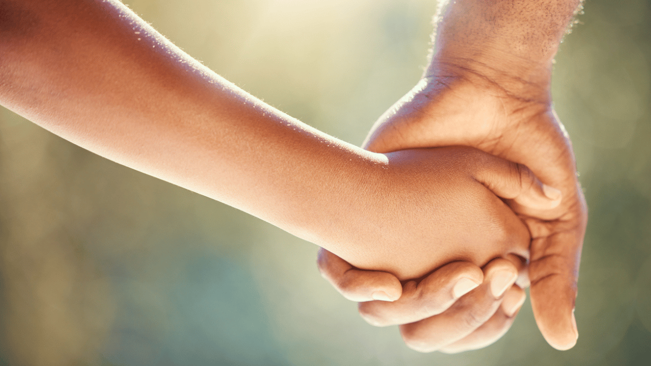 Holding hands with young child