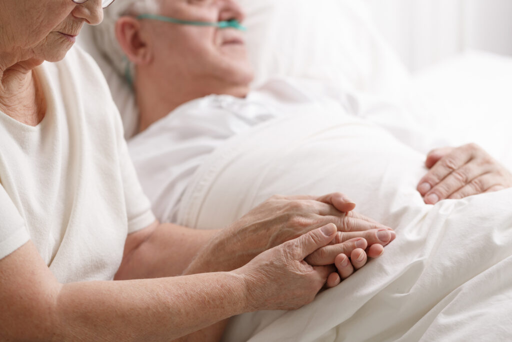 man lying in hospital bed