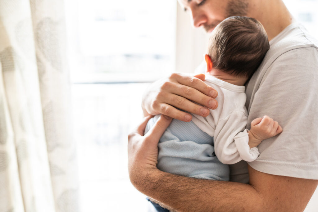 baby in dads arms