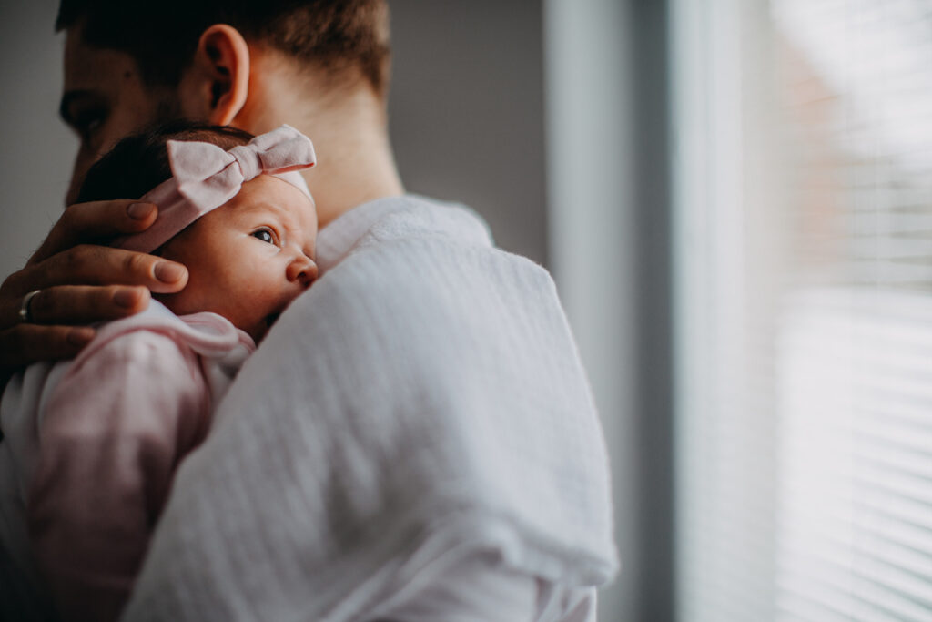 Parent holding newborn baby
