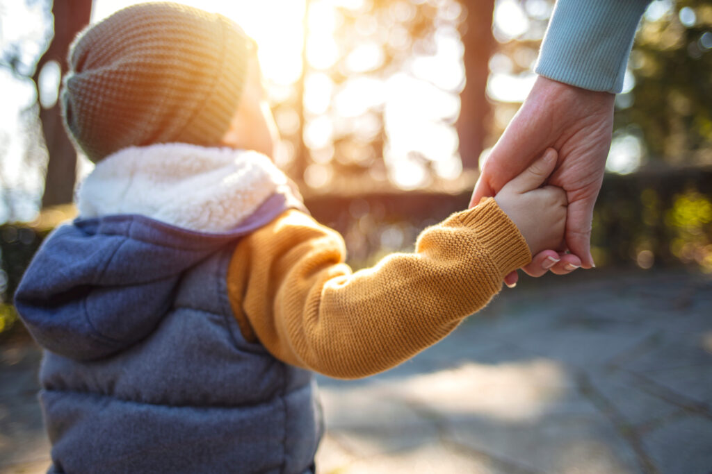 child walking with mother