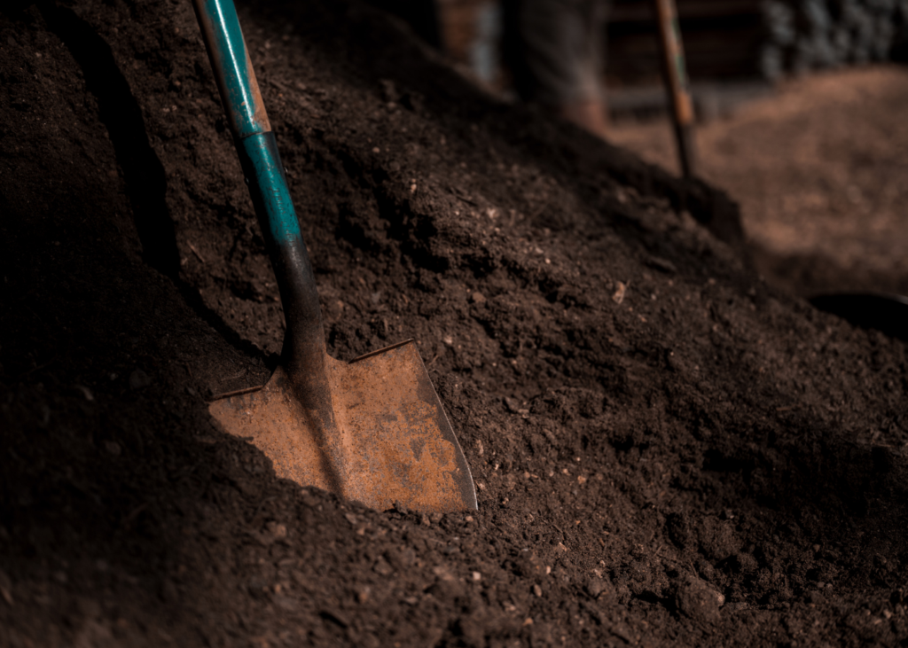 image of shovel in soil containing asbestos